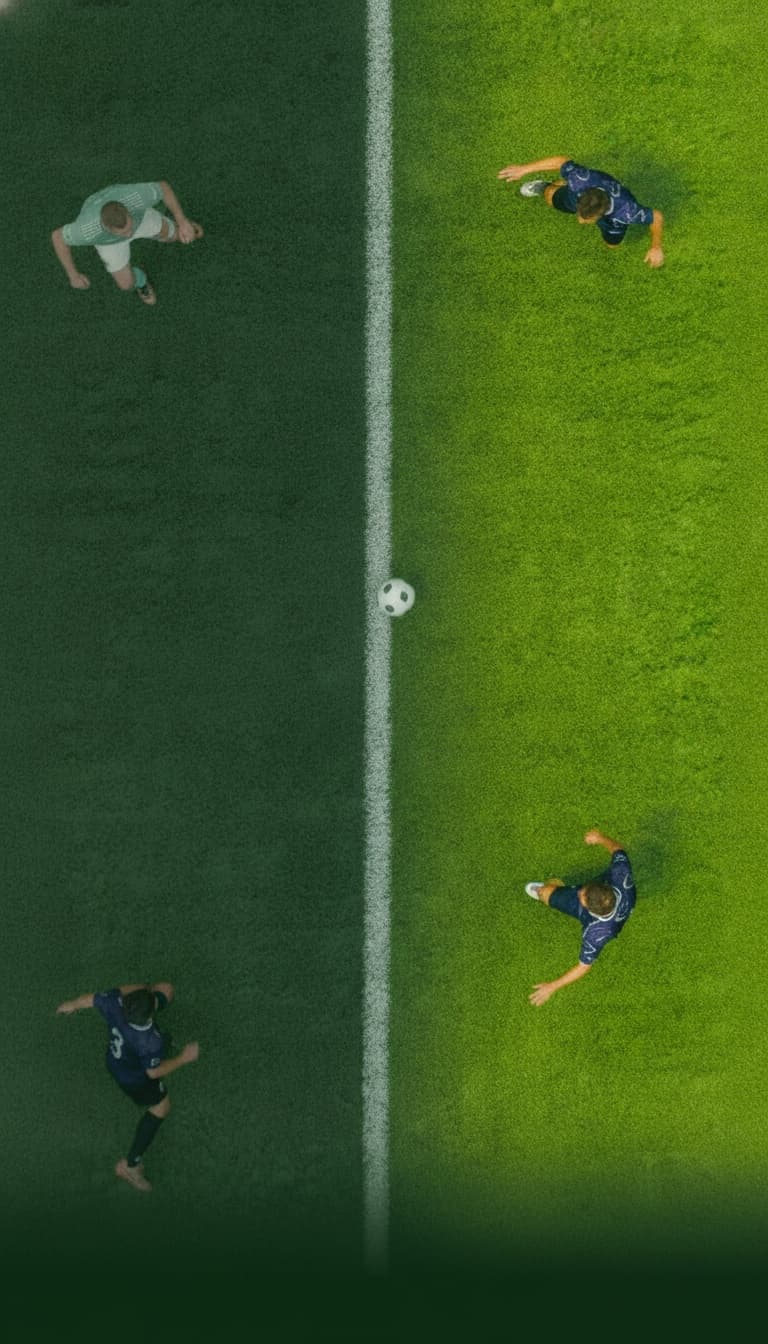 Four football players seen from above around the halfway line